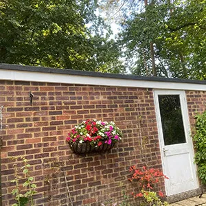 A brick building with a flower box on the wall.