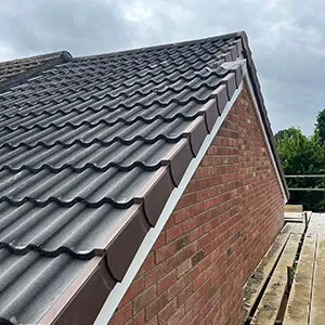 A red brick building with a metal roof.