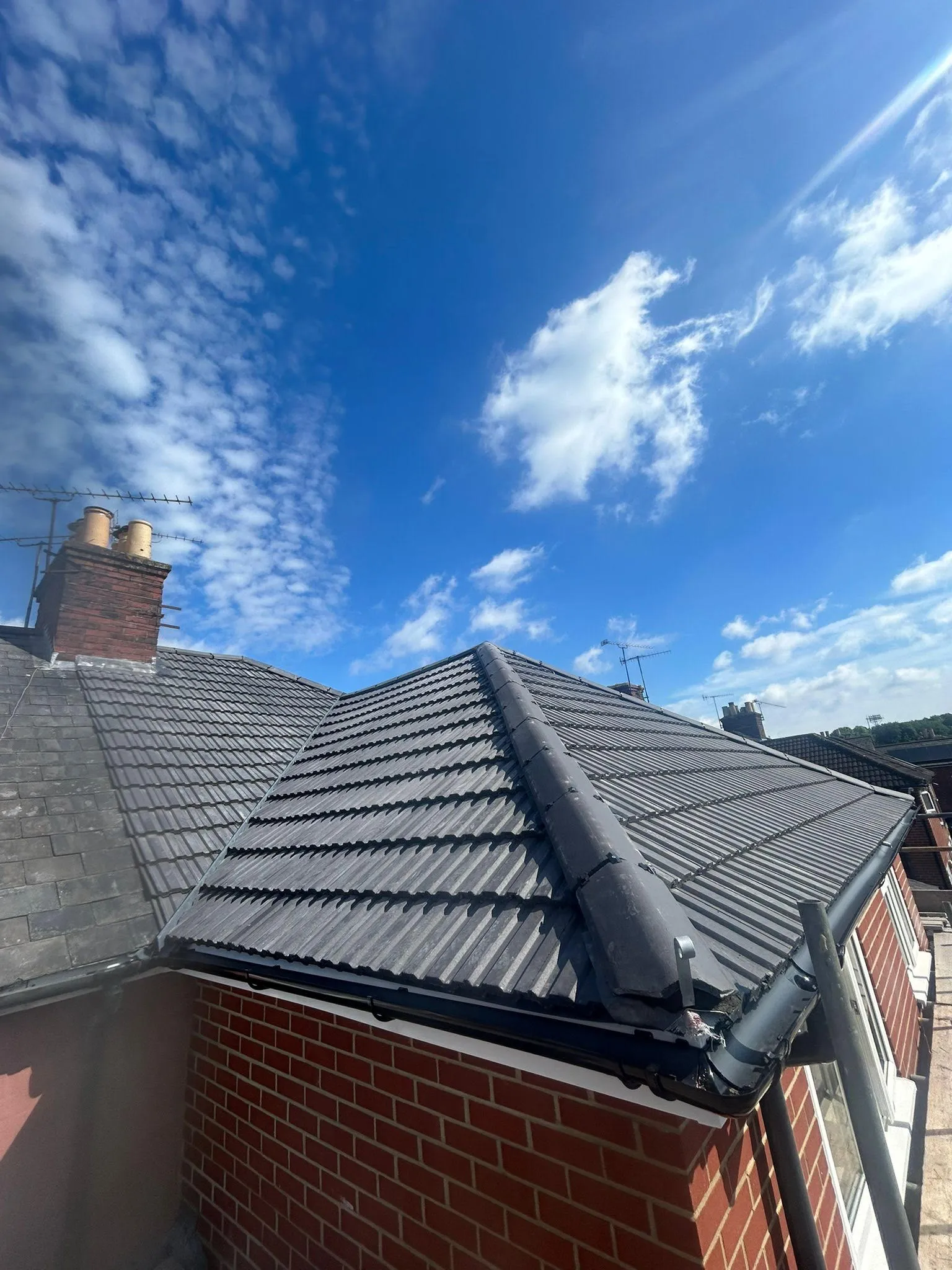 A view of a roof with a sky background.