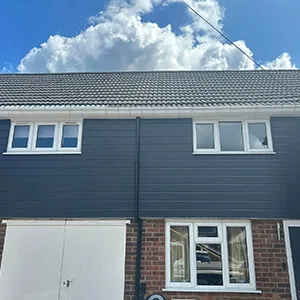 A two story brick house with a garage.