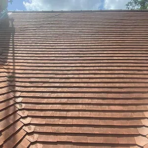 A man is standing on the roof of a building.